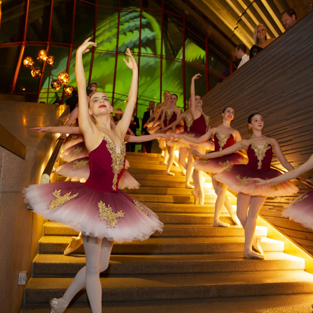 Unique-Luxe-Event-Stylist-Sydney Image of a private event celebrated at the Sydney Opera House in Sydney with a stunning reception with ballet dancers lining the iconic staircase.